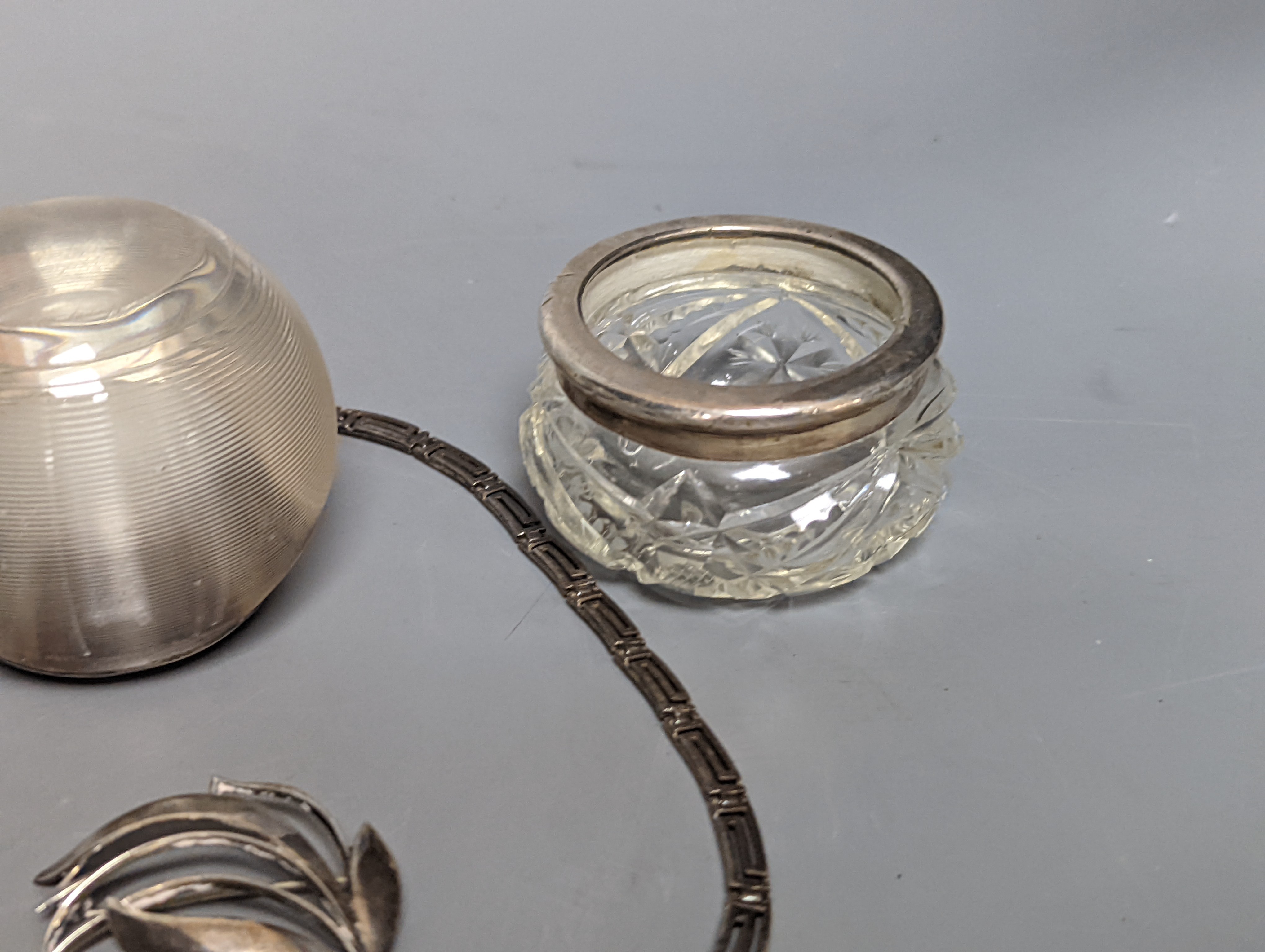 A Danish sterling foliate brooch, 5cm, a 925 'Greek Key' necklace and three silver mounted glass items including an early 20th century match tidy.